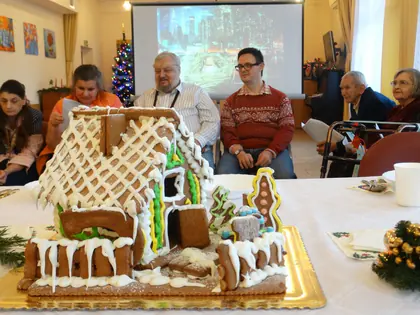 Domek z piernika z lukrowanymi dachówkami na wigilijnym stole