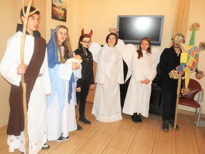 Młodzież w strojach jasełkowych: Józef, Maryja, aniołowie i diabeł